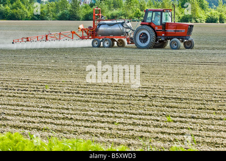 Ein Traktor zieht eine Spray-Rig sprüht einen frisch gepflanzten Kartoffelacker zur Unkrautbekämpfung im nordwestlichen Washington Stockfoto