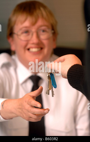 EIN WACHMANN AUF PATROUILLE PÄSSE-TASTEN, UM EINE FRONT DESK SECURITY OFFICER AT A BUSINESS RÄUMLICHKEITEN UK Stockfoto