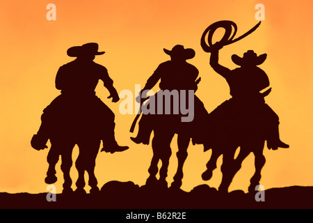 Silhouette der drei Männer reiten Stockfoto