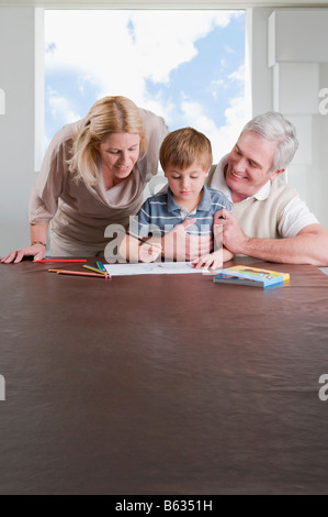 Boy Hausaufgaben mit Hilfe seiner Mutter und Großvater Stockfoto