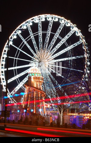 Riesenrad & durcheinander am Cardiff Winter Wonderland. Feuerwehrauto Lichtspuren im Vordergrund. Stockfoto