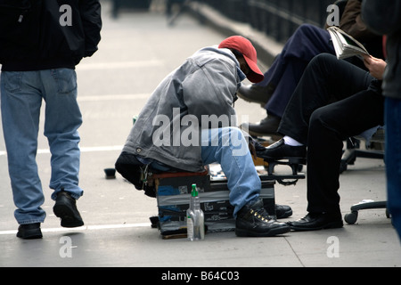 Mann Polieren Schuhe der Geschäftsmann auf der Straße von New York City. Manhattan, NY USA