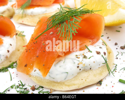 Häppchen von Wild Alaskan Coho Räucherlachs auf Blinis mit Sauerrahm und Dill. Stockfoto