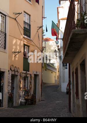 Ältere Frau, Blick aus dem Fenster über ein Geschenk-Shop auf der Rua de Santa Cruz Castelo, Santa Cruz, Lissabon, Portugal Stockfoto