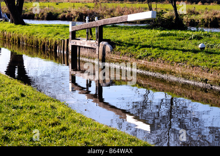 Eine Schleuse spiegelt sich im Wasser vor den Toren Worsfold auf dem Fluss Wey Navigation in Surrey England Stockfoto