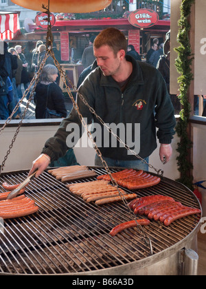 Kochen Würstchen auf dem deutschen Weihnachtsmarkt in Kingston upon Thames, Surrey, England Stockfoto