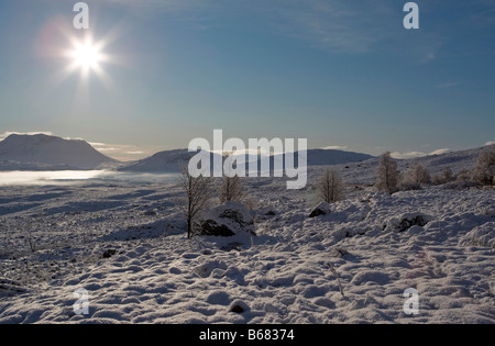 Schönen guten Morgen Szene über Rannoch Moor Schnee Hervorhebung der frühen Morgennebel, den gefrorenen See und atemberaubende auf Berge Stockfoto