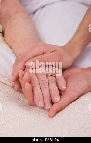 Frau mit senior Frauenhand auf Bett, Nahaufnahme Stockfoto