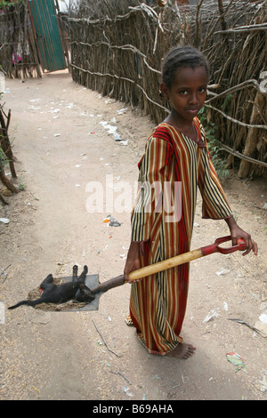 Äthiopische Mädchen im Flüchtlingslager in Dadaab, an der Grenze zwischen Kenia und Somalia. Sie hat einen sterbenden, nicht noch Tote Katze Om ihr Spaten. Stockfoto