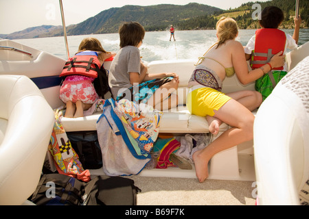 Familie in einem Motorboot und Blick auf eine Person Wasserski, Lake Chelan, Washington State, USA Stockfoto