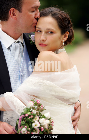 Ehemann seine hübsche neue Frau Tenderley auf Stirn küssen Stockfoto