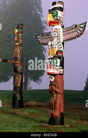 Kwakwaka (Kwakiutl) Stil Totempfähle an einem nebeligen Tag am Brockton Point im Stanley Park in Vancouver British Columbia Kanada Stockfoto