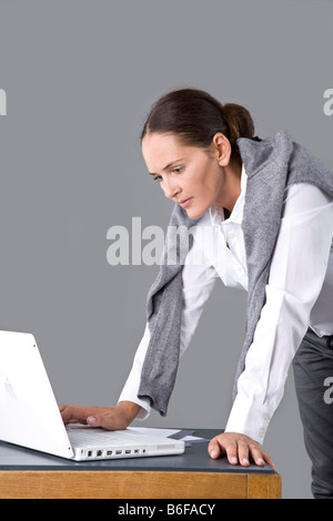 Junge Frau an ihrem Schreibtisch arbeiten Stockfoto