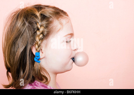 Kleines Mädchen, 9 Jahre alt, ein Kaugummi Seifenblase Stockfoto