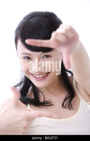 Woman framing her face with her fingers portrait close up Stockfoto