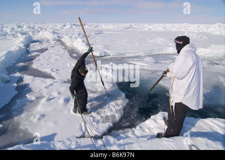 Inupiaq Subsistenz Jäger öffnet ein Loch in das Packeis für potentielle Tierwelt Tschuktschensee passieren Stockfoto