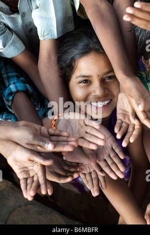 Indische Mädchen lächelndes Gesicht unter spielende Kinder drängten sich zusammen in einer Gruppe. Andhra Pradesh, Indien Stockfoto