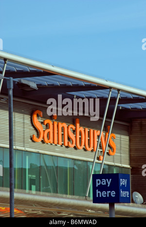 Außenseite des Sainsburys Supermarkt zeigt Logo speichern und Zahlen hier Parkplatz Zeichen in Kingston, Surrey, england Stockfoto