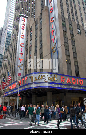 Fußgänger überqueren Sie die Straße vor Radio City Music Hall im Rockefeller Center Manhattan New York City New York Stockfoto