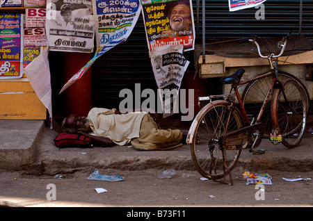 Ein indischer Mann schläft auf der Straße neben dem Fahrrad In Madurai, Süd-Indien, Tamil Nadu Zustand von Indien Stockfoto