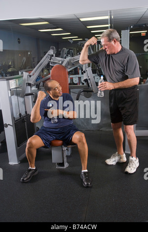 Porträt von Senioren Herren trainieren Sie im Fitnesscenter, Arme beugen Stockfoto