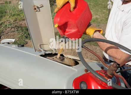 Bauern Hände Traktor von roten Gas tanken können Stockfoto