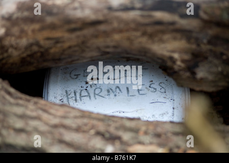 Geocache-Schatzkiste gefunden in der Landschaft unter einem Protokoll-Stapel Stockfoto