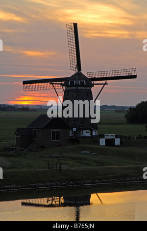 holländische Windmühle roten Sonnenuntergang Hintergrundbeleuchtung Holland Texel Insel Sillhouette Abendrot Abendstimmung Stockfoto