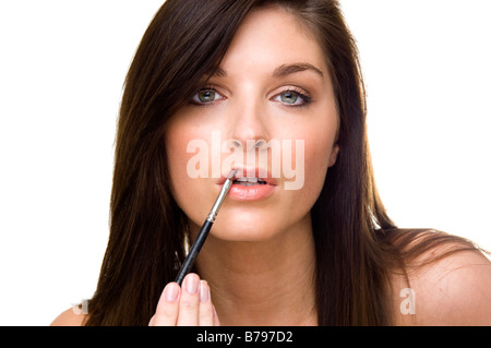 Frau Lipgloss mit einem Pinsel auftragen Stockfoto