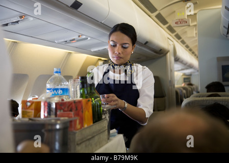 Flugbegleiter / air Stewardess serviert Getränke für Passagiere aus einem Trolley Wagen während des Fluges (45) Stockfoto