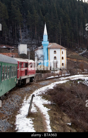 Schmalspur-Bahn vorbei an einer Moschee in Yakoruda, Bulgarien. Stockfoto