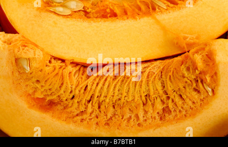 Nahaufnahme von zwei Scheiben Orange Kürbis Samen und Fleisch zeigen Stockfoto