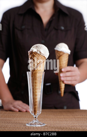 Person, die Eiscreme-Kegel mit Stracciatella-Eis Stockfoto