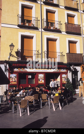 Personen, die in der Calle Segovia vor dem Restaurant Taberna El Madroño, Plaza Puerta Cerrada, Madrid, Spanien, sitzen Stockfoto