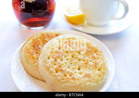 Ein Frühstück-Einstellung von Fladenbrot mit eine Karaffe mit Schwarztee und Wasserglas mit einer Scheibe Zitrone Om weißen Hintergrund Stockfoto