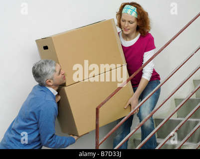 Ein paar Boxen zusammen Treppe hinauf tragen Stockfoto