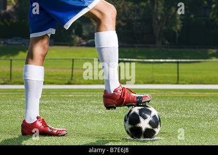 Beine eines Fußballer und Fußball Stockfoto