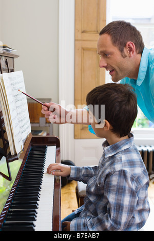 Vater Sohn beizubringen, wie man Klavier spielen Stockfoto