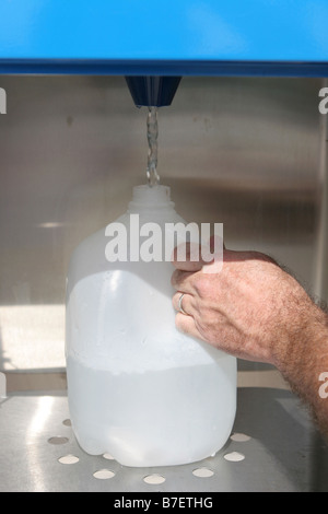 Eine Mann s Hand Nachfüllen einen Wasserkrug und ein Getränkeautomat zur Vorbereitung einer Naturkatastrophe kann auch verwendet werden, für das recycling Stockfoto