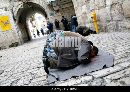 Palästinensische Muslime beten außerhalb der Al Aqsa Moschee Verbindung in die Altstadt von Jerusalem. Stockfoto