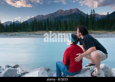 Ein paar genießt den Sonnenuntergang am Ufer des Kootenay River im Kootenay National Park Stockfoto