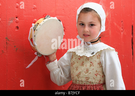 Junges Mädchen in Tracht mit einem Tamburin in Saintes-Maries De La Mer, Frankreich Stockfoto