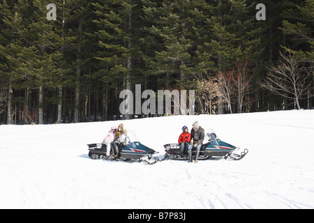 Familie Reiten auf Motorschlitten Stockfoto