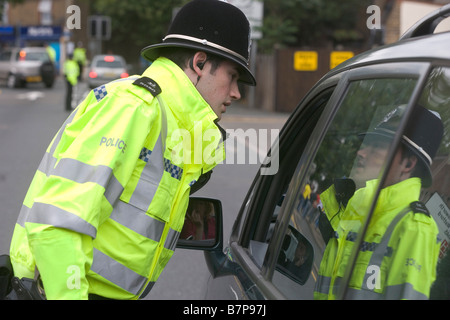 Polizeibeamter spricht einen Treiber beim diensthabenden Verkehr als Unterstützer für das Watford Burnley Spiel ankommen Stockfoto