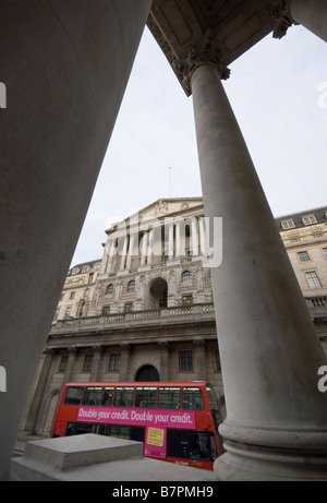 Einem roten Londoner Bus mit einer Anzeige sagt "Double Your Credit" vorbeifahren der Bank of England, in der City of London. Stockfoto