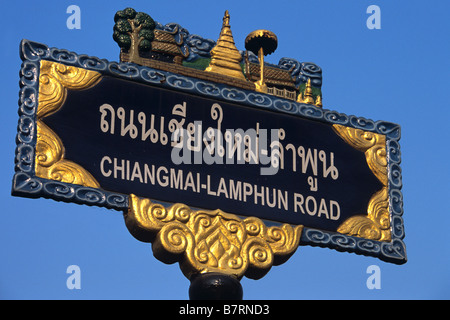 Zweisprachiges Straßenschild, Chiang Mai - Lumphun Straße, Chiang Mai, geschrieben in Thai Alphabet & Englisch Roman Script, Nord-Thailand Stockfoto