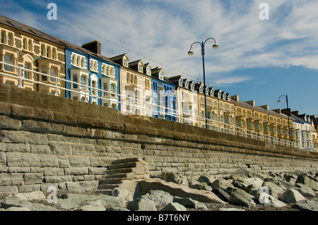 Reihenhäuser am Meer mit ihrer farbenfrohen Darstellung auf der Victoria Terrace, aufgenommen vom Strand in Aberystwyth, Wales. Stockfoto