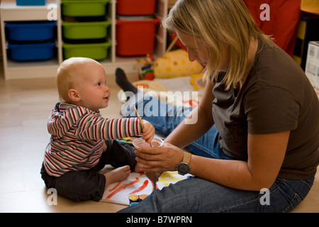 Baby-Mädchen und Mutter malen Deutschland September 2008 Stockfoto