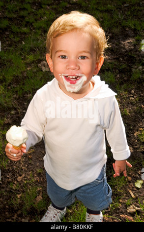 kleiner Junge hält Eis lächelnd Stockfoto