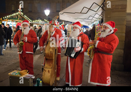 Straßenmusiker mit Weihnachtsmann-Kostüme, Weihnachtszeit, Straßburg, Elsass, Frankreich Stockfoto